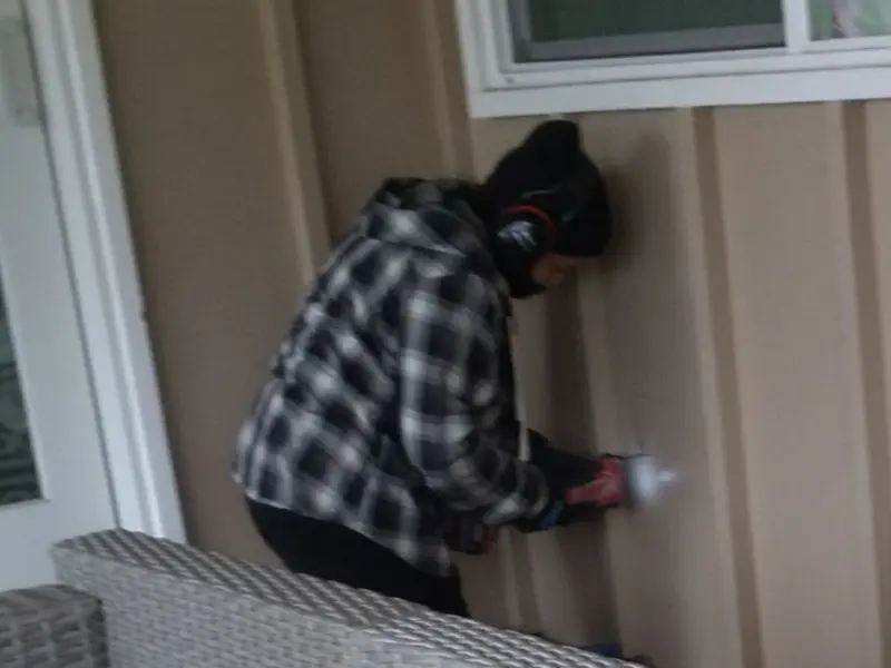 Professional electrician installing an exterior outlet in Great Neck