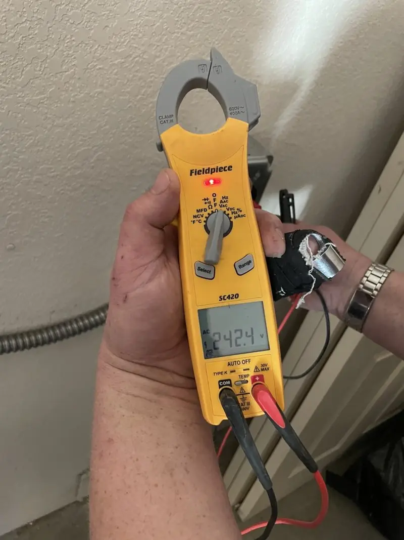 Voltage testing with clamp meter during Electrical Installation Services in Great Neck